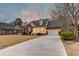 Brick home with a two-car garage, a front porch, and a colorful sunset sky at 1006 Retreat Ave, Moncks Corner, SC 29461