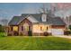 Charming brick home features a well-manicured lawn, inviting front porch, and attached two-car garage at 1006 Retreat Ave, Moncks Corner, SC 29461