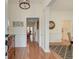 Inviting foyer with hardwood floors, white wainscoting, columns, and view into the living areas at 1006 Retreat Ave, Moncks Corner, SC 29461