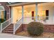 Inviting front porch featuring classic columns, brick steps, and charming railings on a well-maintained property at 1006 Retreat Ave, Moncks Corner, SC 29461