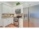 Bright kitchen with white cabinets, stainless steel appliances, and stylish backsplash at 1006 Retreat Ave, Moncks Corner, SC 29461
