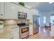 Bright kitchen featuring stainless steel appliances, granite countertops, and white cabinetry at 1006 Retreat Ave, Moncks Corner, SC 29461
