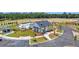 An aerial view of a white community center, parking lot, pool, and playground at 107 Crosscut Ln, Summerville, SC 29486