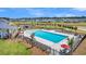 Aerial view of community pool with lounge chairs, tables, pool house, and surrounding landscaping at 107 Crosscut Ln, Summerville, SC 29486