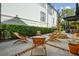 Expansive patio with travertine and brick details, features outdoor lounge and a charming water feature at 111 S Battery St, Charleston, SC 29401