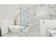 Bathroom features marble walls, glass shower, marble countertops, and freestanding tub at 111 S Battery St, Charleston, SC 29401