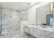 Bathroom featuring marble shower, marble countertop and a framed mirror at 111 S Battery St, Charleston, SC 29401