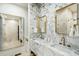 Modern bathroom featuring double sinks, marble counters, and brass fixtures that add to the luxurious feel at 111 S Battery St, Charleston, SC 29401