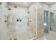 Large bathroom featuring marble tiling, glass-enclosed shower, and modern fixtures for a luxurious experience at 111 S Battery St, Charleston, SC 29401