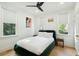 Bright bedroom features hardwood floors, a queen bed, and natural light from three windows at 111 S Battery St, Charleston, SC 29401