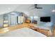 Bedroom with vaulted ceiling, built-in desk, a TV, and light hardwood floors at 111 S Battery St, Charleston, SC 29401
