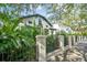 Charming two-story home framed by lush greenery and an iron fence at 111 S Battery St, Charleston, SC 29401