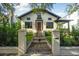 Charming two-story home with a brick pathway, iron gate, and lush green lawn at 111 S Battery St, Charleston, SC 29401