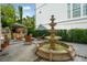Picturesque outdoor oasis with a classic tiered fountain and outdoor grilling area at 111 S Battery St, Charleston, SC 29401