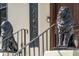 Close up of front porch with elegant lion statues at the base of the staircase at 111 S Battery St, Charleston, SC 29401