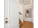 Hallway view showing the hardwood herringbone floors and decorative painting on the wall going up the stairs at 111 S Battery St, Charleston, SC 29401