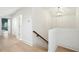 Bright hallway with hardwood floors leading to bedroom and staircase at 111 S Battery St, Charleston, SC 29401