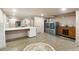 This is a bright laundry room with a large mirror and vanity with modern washer and dryer units at 111 S Battery St, Charleston, SC 29401