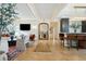Open-concept living room featuring herringbone floors, modern furniture, and a large mirror reflecting the home's entryway at 111 S Battery St, Charleston, SC 29401