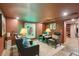 The living room boasts stylish leather seating under bright lighting with a quirky neon art piece at 111 S Battery St, Charleston, SC 29401