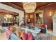 Spacious living room with elegant chandelier, marble table, and hardwood floors at 111 S Battery St, Charleston, SC 29401