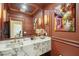 Stylish powder room features marble countertops, warm lighting, and an artistic color scheme at 111 S Battery St, Charleston, SC 29401