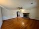 Spacious living room featuring hardwood floors and a classic brick fireplace at 113 Germantown Rd, Summerville, SC 29483