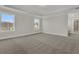 Bright bedroom featuring gray walls, neutral carpeting, and two windows at 117 Grange Cir, Summerville, SC 29486
