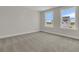 Bright bedroom with neutral carpet and trim, featuring large windows with natural light at 117 Grange Cir, Summerville, SC 29486