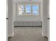 Hallway with gray cabinets under window and neutral carpet flooring at 117 Grange Cir, Summerville, SC 29486