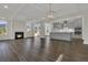 Open-concept space with fireplace, recessed lights, hardwood floors, kitchen with island, and stainless appliances at 117 Grange Cir, Summerville, SC 29486