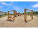Outdoor community playground featuring wooden swings and play structures, perfect for neighborhood children at 117 Grange Cir, Summerville, SC 29486