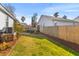 Well-maintained backyard with green grass, mulch beds, and privacy fence at 1236 Lakefront Dr, Charleston, SC 29412
