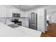 Bright kitchen with stainless steel appliances, white cabinets and solid surface countertops at 1236 Lakefront Dr, Charleston, SC 29412