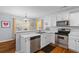 Well lit Kitchen featuring stainless steel appliances, white cabinetry, solid surface countertops and a breakfast bar at 1236 Lakefront Dr, Charleston, SC 29412