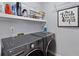 Laundry room featuring modern washer and dryer with storage shelves at 1236 Lakefront Dr, Charleston, SC 29412