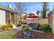 Cozy brick patio with seating area and red umbrella for outdoor relaxation at 1236 Lakefront Dr, Charleston, SC 29412