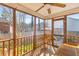 Relaxing screened-in porch with wooden furniture, offering a cozy outdoor living space at 1236 Lakefront Dr, Charleston, SC 29412