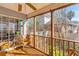 Charming screened-in porch with natural wood floors and furniture, perfect for outdoor enjoyment at 1236 Lakefront Dr, Charleston, SC 29412