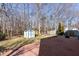 A spacious deck overlooks the backyard with a storage shed surrounded by mature trees at 129 E Hartwick Ln, Goose Creek, SC 29445