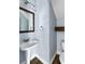 Cozy bathroom features pedestal sink and a wooden framed mirror at 129 E Hartwick Ln, Goose Creek, SC 29445