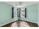 Bedroom with mint walls has two bright windows and dark wood floors at 129 E Hartwick Ln, Goose Creek, SC 29445