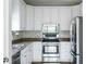 Modern kitchen features stainless steel appliances, white cabinetry, and stylish backsplash at 129 E Hartwick Ln, Goose Creek, SC 29445