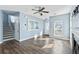 Bright living room with light blue walls, hardwood floors, a staircase, and a front door at 129 E Hartwick Ln, Goose Creek, SC 29445
