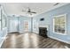 Light-filled living room features light blue walls, a cozy fireplace, ceiling fan and beautiful flooring at 129 E Hartwick Ln, Goose Creek, SC 29445