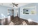 Spacious living room featuring hardwood floors, light blue walls, and a large mirror at 129 E Hartwick Ln, Goose Creek, SC 29445