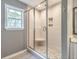 Bathroom features a gray tiled walk-in shower with a corner seat and mosaic accents at 129 E Hartwick Ln, Goose Creek, SC 29445