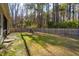 Spacious fenced backyard featuring mature trees and an outdoor seating area at 1601 Thin Pine Dr, Johns Island, SC 29455