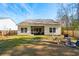 Large, fenced backyard with a screened porch, outdoor chairs, and a fire pit at 1601 Thin Pine Dr, Johns Island, SC 29455