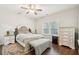 Bright bedroom featuring hardwood floors, a ceiling fan, and a large window with natural light at 1601 Thin Pine Dr, Johns Island, SC 29455